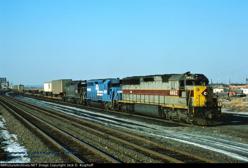 CR, Conrail SD45-2 6662 ex-EL 3677-CR GP40 3219 ex-PC- CR GP40 3013 ex-NYC, is nearing the end of its eastbound trip with TV98. The train has just crossed the river at HX and is entering the ex-Erie Croxton yard at Secaucus, New Jersey. February 10, 1977.